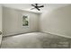 Bright bedroom featuring neutral carpet, walls, ceiling fan, and a natural light filled window at 147 35Th Ne Ave, Hickory, NC 28601