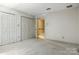 Open bedroom featuring two closets and an open doorway to a hallway at 147 35Th Ne Ave, Hickory, NC 28601