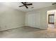 Bedroom includes carpeted floor, closet, ceiling fan, and leads into another room at 147 35Th Ne Ave, Hickory, NC 28601