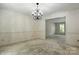 A dining room with chair railing features a chandelier, white walls and neutral carpet at 147 35Th Ne Ave, Hickory, NC 28601
