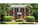 Close-up view of a brick home with black shutters and an awning over the front door at 147 35Th Ne Ave, Hickory, NC 28601