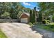 Brick house with an attached garage, surrounded by green trees and a wooden fence at 147 35Th Ne Ave, Hickory, NC 28601