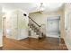 Inviting foyer with hardwood floors, a staircase, and classic wainscoting at 147 35Th Ne Ave, Hickory, NC 28601