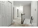 Well-lit carpeted hallway featuring two doors and wooden railing on staircase at 147 35Th Ne Ave, Hickory, NC 28601