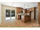 Eat-in kitchen with central island, wood cabinets, tile floors and access to the deck at 147 35Th Ne Ave, Hickory, NC 28601