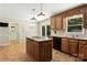 Charming kitchen with a center island, warm wood cabinetry, and a breakfast nook with sliding glass doors at 147 35Th Ne Ave, Hickory, NC 28601