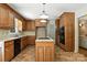 A full kitchen view showcases wooden cabinets, countertops, kitchen island with built in cooktop, and appliances at 147 35Th Ne Ave, Hickory, NC 28601