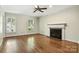 Cozy living room featuring a fireplace, hardwood floors, and plantation shutters at 147 35Th Ne Ave, Hickory, NC 28601