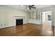 Bright living room with a fireplace, built-in shelving, and gleaming hardwood floors at 147 35Th Ne Ave, Hickory, NC 28601