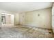 A spacious living room with neutral carpet is next to a dining area with chandelier at 147 35Th Ne Ave, Hickory, NC 28601