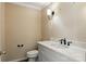 Cozy powder room featuring a marble countertop and classic fixtures at 147 35Th Ne Ave, Hickory, NC 28601