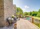 Back deck with brick and wooden rails. Overlooks the pool area and has comfortable wicker furniture at 1508 Avalon Oaks Ct, Dallas, NC 28034