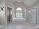Luxurious bathroom features a soaking tub under a large window and a separate glass enclosed shower at 1508 Avalon Oaks Ct, Dallas, NC 28034