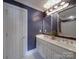 Bathroom with white cabinets, double sink, chrome fixtures, navy blue walls and bright lighting at 1508 Avalon Oaks Ct, Dallas, NC 28034