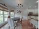 Bright breakfast nook connected to kitchen featuring a modern chandelier at 1508 Avalon Oaks Ct, Dallas, NC 28034