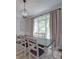 This dining room features a chandelier, a large window and a long dining table at 1508 Avalon Oaks Ct, Dallas, NC 28034