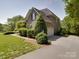 A brick two-story home with mature landscaping, an attached two-car garage and a concrete driveway at 1508 Avalon Oaks Ct, Dallas, NC 28034