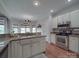 Bright kitchen features granite countertops, stainless steel appliances and a breakfast nook with large windows at 1508 Avalon Oaks Ct, Dallas, NC 28034