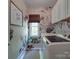 Bright laundry room with modern washer/dryer, flower wallpaper and window with custom woven shade at 1508 Avalon Oaks Ct, Dallas, NC 28034