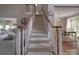 Carpeted staircase with white railing leads to a dining room with hardwood floors and natural light at 1508 Avalon Oaks Ct, Dallas, NC 28034