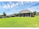 A large backyard features a modern home with a covered patio and ample green space at 163 Crenshaw Nw Pl, Concord, NC 28027
