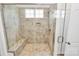 Close up of the luxurious tiled walk-in shower with bench and glass door at 163 Crenshaw Nw Pl, Concord, NC 28027