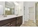 Bright bathroom with double sinks, granite countertops, and tiled walk-in shower at 163 Crenshaw Nw Pl, Concord, NC 28027