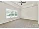 Bright bedroom with a tray ceiling, ceiling fan and large window at 163 Crenshaw Nw Pl, Concord, NC 28027