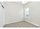 Bright bedroom with large window allowing for ample natural light and neutral carpeting at 163 Crenshaw Nw Pl, Concord, NC 28027