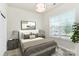A bedroom with a large window, a cozy bed, and stylish decor at 163 Crenshaw Nw Pl, Concord, NC 28027