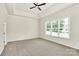 Spacious bedroom with tray ceilings, a ceiling fan, and a large window for natural light at 163 Crenshaw Nw Pl, Concord, NC 28027