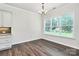 Bright dining area with large window and chandelier is located adjacent to the kitchen at 163 Crenshaw Nw Pl, Concord, NC 28027