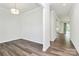 Bright dining room boasts neutral walls, modern light fixture, and elegant wood floors at 163 Crenshaw Nw Pl, Concord, NC 28027