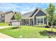 Exterior front elevation of home featuring a well-manicured lawn and elegant architectural details at 163 Crenshaw Nw Pl, Concord, NC 28027