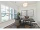 Bright home office featuring a modern desk, stylish decor, and large windows for ample natural light at 163 Crenshaw Nw Pl, Concord, NC 28027