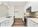 Updated kitchen with stainless steel appliances and sleek countertops, including the kitchen island at 163 Crenshaw Nw Pl, Concord, NC 28027