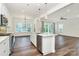 Open concept kitchen with stainless appliances, an island and view into the dining and living area at 163 Crenshaw Nw Pl, Concord, NC 28027
