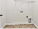 The functional laundry room features tile flooring and convenient utility connections at 163 Crenshaw Nw Pl, Concord, NC 28027