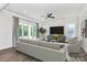 Spacious living room with contemporary furniture, ceiling fan, and large windows for a bright and airy feel at 163 Crenshaw Nw Pl, Concord, NC 28027