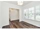 Bright room features neutral walls, modern lighting fixture, and beautiful wood floors at 163 Crenshaw Nw Pl, Concord, NC 28027