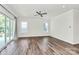 Bright living room with abundant natural light, sleek ceiling fan, and beautiful wood floors at 163 Crenshaw Nw Pl, Concord, NC 28027