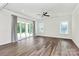 Spacious living room with ample natural light, modern ceiling fan, and wood flooring at 163 Crenshaw Nw Pl, Concord, NC 28027