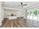 Open-concept living room features a modern kitchen and sliding glass doors to the backyard at 163 Crenshaw Nw Pl, Concord, NC 28027