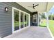 Covered patio features a ceiling fan, exterior lighting, and sliding glass doors leading inside at 163 Crenshaw Nw Pl, Concord, NC 28027