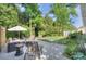 Expansive backyard featuring a patio area, mature trees, storage shed, and lush green lawn at 1715 Wensley Dr, Charlotte, NC 28210