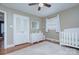 Neutral Bedroom with hardwood floors, a crib, dresser, and bright windows for a cheerful atmosphere at 1715 Wensley Dr, Charlotte, NC 28210