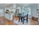 Bright kitchen dining area with white cabinets, an island, and black dining furniture at 1715 Wensley Dr, Charlotte, NC 28210