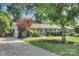Beautifully landscaped home featuring manicured lawn, flowering shrubs, and a welcoming facade at 1715 Wensley Dr, Charlotte, NC 28210