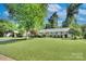 Charming home showcasing a well-maintained lawn and mature trees at 1715 Wensley Dr, Charlotte, NC 28210