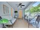 Cozy screened porch featuring comfortable lounge furniture, a mini fridge and outdoor tv for relaxation at 1715 Wensley Dr, Charlotte, NC 28210